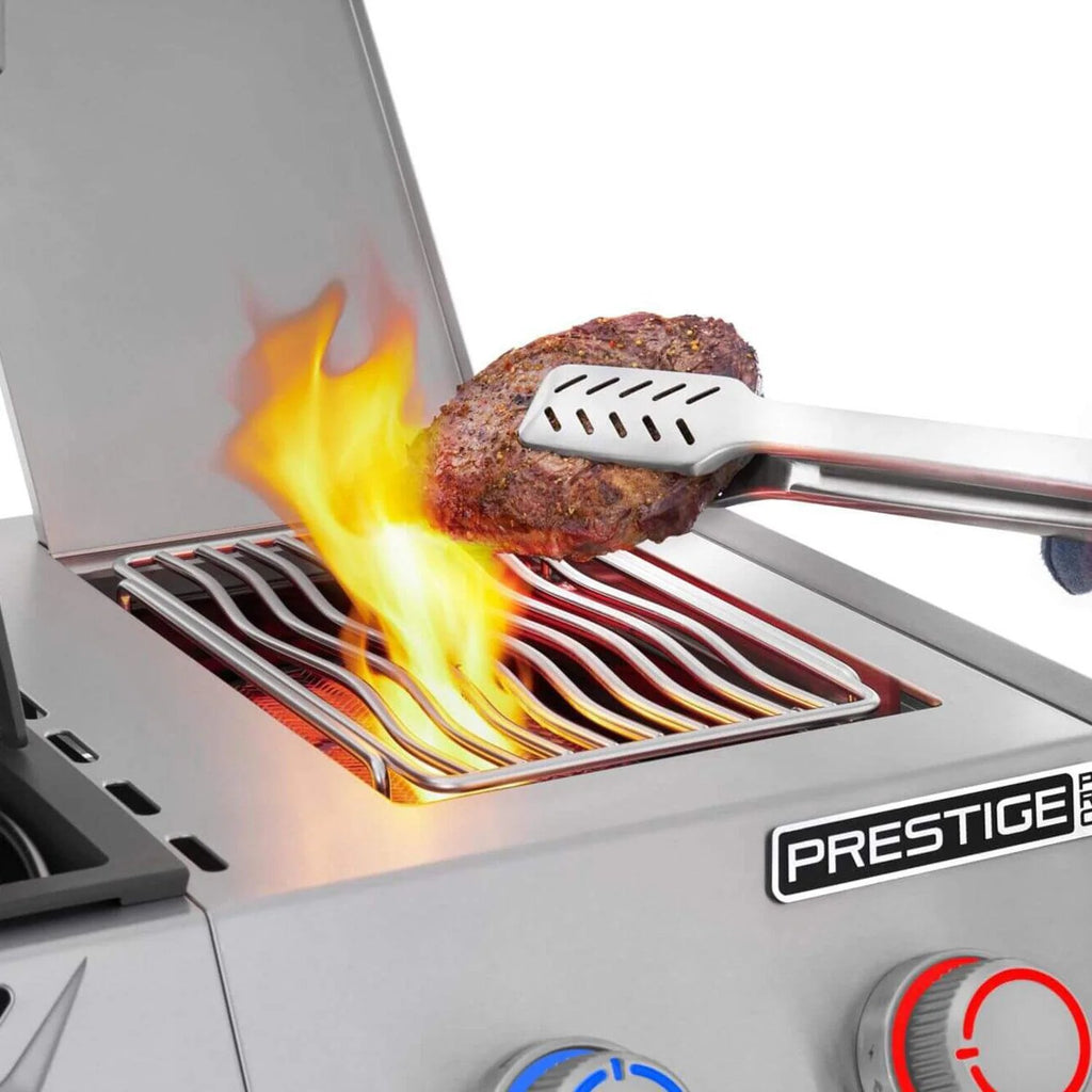 Sizzling steak on Prestige grill with flames, perfect for BBQ enthusiasts